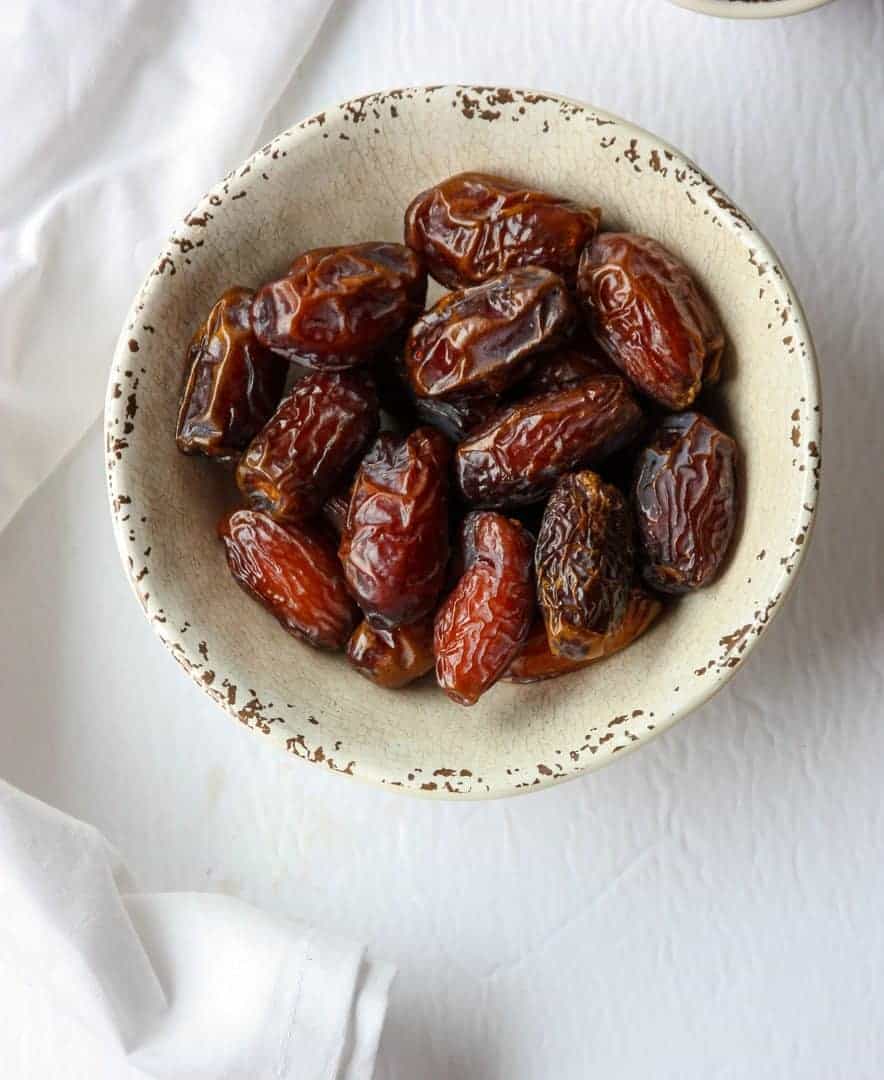 A bowl of dates on a table